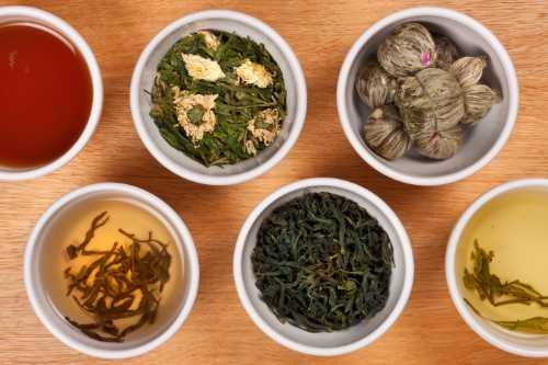 Loose-leaf herbal teas in small white bowls