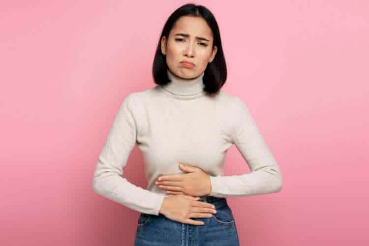 Woman holding her stomach in discomfort