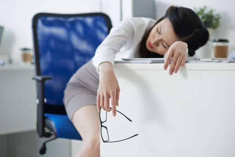 Woman resting her head on a desk